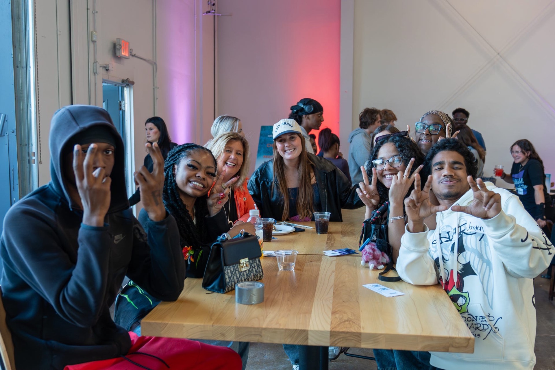 A group of teenagers gathered around a table