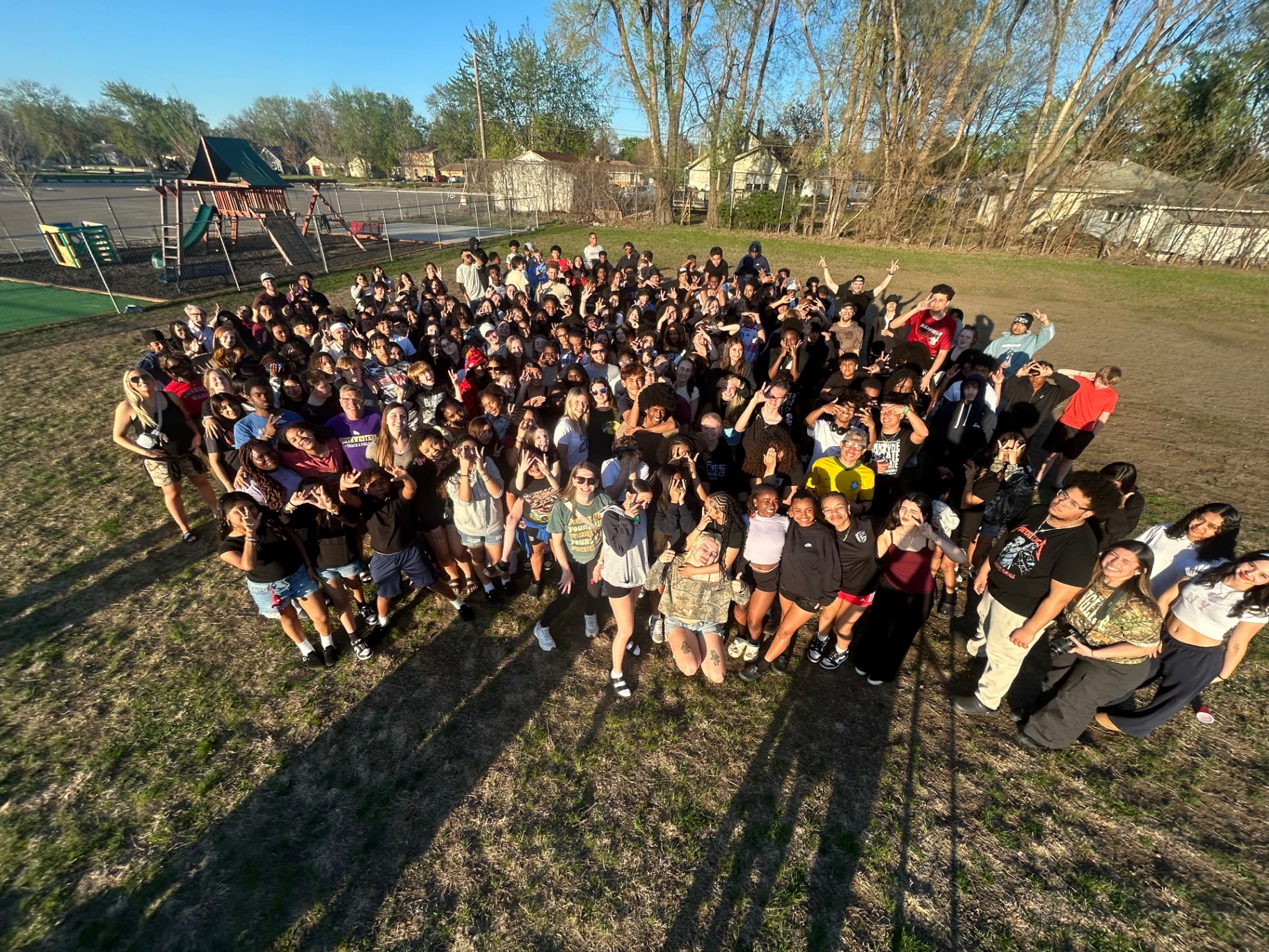 Large group of teenagers gathered together outdoors